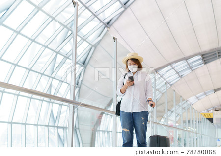 New Normal tourist wearing face mask is traveling on The airport , New lifestyle travel after covid-19. Social distancing healthcare system ,stay safe and Travel bubble concept. New Normal tourist wearing face mask is traveling on The airport , New lifestyle travel after covid-19. Social distancing healthcare system ,stay safe and Travel bubble concept. 78280088