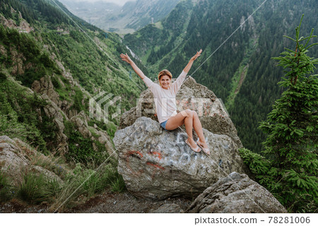 Girl on the cliff edge near Transfegerasan mountain road. Girl on the cliff edge near Transfegerasan mountain road. 78281006