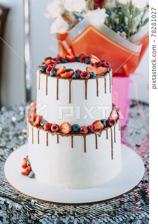 Chocolate cake with whipped cream and fresh berries. Close up. Sponge cake with strawberries and vanilla cream. Chocolate cake with whipped cream and fresh berries. Close up. Sponge cake with strawberries and vanilla cream. 78281027