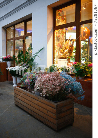 luminous large windows of a flower shop with large flower beds on the street luminous large windows of a flower shop with large flower beds on the street 78281367