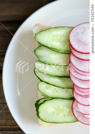 Cucumber and radish open sandwich with topping 78282584