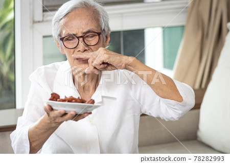 Senior woman holding plate of bad spoiled or expired food in her hand,rotten food,emitting a fetid smell or strong-smelling food,disgusted old elderly cover nose with her finger,diet,nutrition concept Senior woman holding plate of bad spoiled or expired food in her hand,rotten food,emitting a fetid smell or strong-smelling food,disgusted old elderly cover nose with her finger,diet,nutrition concept 78282993