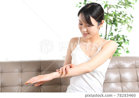 Image of a young woman doing body care Image of a young woman doing body care 78283460