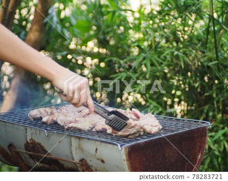 fresh delicious grilled pork on charcoal grill with salt and traditional soya source at rural outdoor stove authentic shot in a summer party fresh delicious grilled pork on charcoal grill with salt and traditional soya source at rural outdoor stove authentic shot in a summer party 78283721