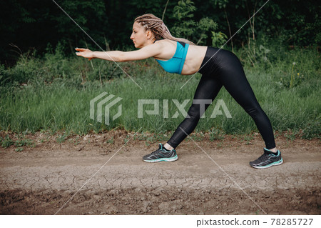 Outdoor sports. Fit woman warming up exercising Outdoor sports. Fit woman warming up exercising 78285727