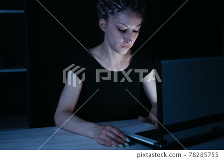 Young focused woman doing overtime job at night 78285755