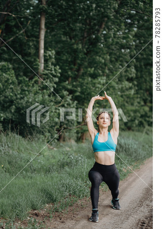 Beautiful sporty woman stretching body in nature Beautiful sporty woman stretching body in nature 78285793