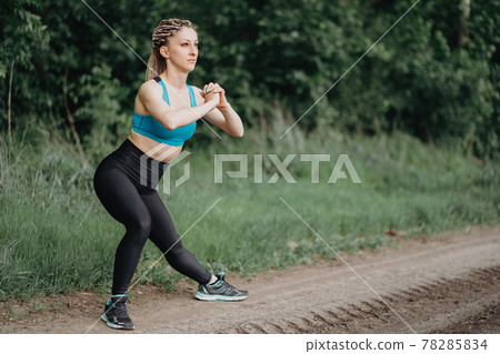 Fit sporty woman in sportswear stretching legs 78285834