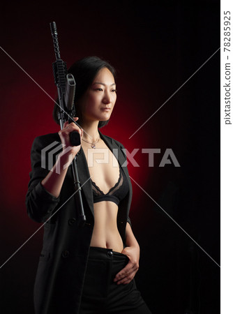 asian woman in a jacket with an automatic rifle in her hands mafia fighter asian woman in a jacket with an automatic rifle in her hands mafia fighter 78285925
