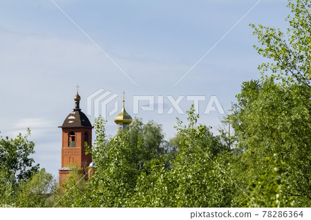 Old village church surrounded by forest in the early morning. Old village church surrounded by forest in the early morning. 78286364