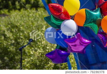 Preparation for the festive children's concert at school and in the pre-school institution of education. Microphone and inflatable balls on stage before a concert. 78286378