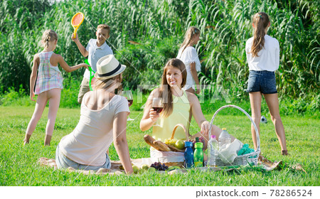 Portrait of smiling mums on picnic with happy children Portrait of smiling mums on picnic with happy children 78286524