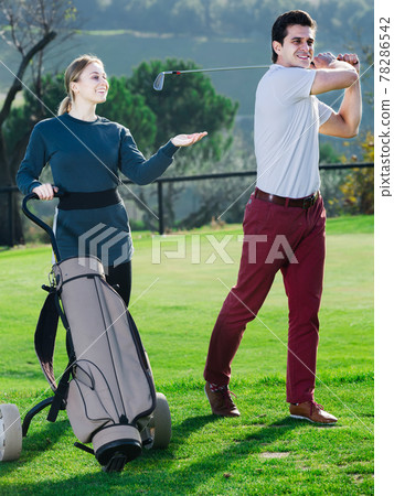 Girl watching the game male golfer Girl watching the game male golfer 78286542
