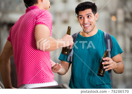 friendly male fans are drinking beer and talking about football outdoor in Barcelona friendly male fans are drinking beer and talking about football outdoor in Barcelona 78286570