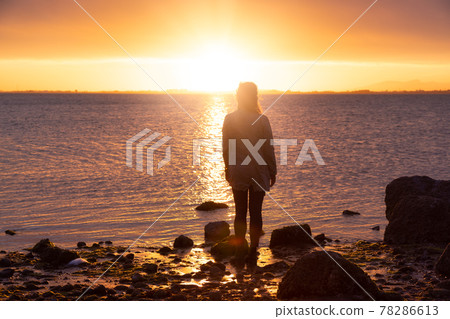 Adventure Caucasian Adult Woman Standing on a rocky beach Adventure Caucasian Adult Woman Standing on a rocky beach 78286613
