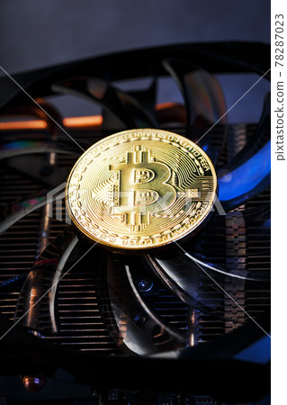 Gold bitcoins on a video card with a blue backlight in the style of cyberpunk. Gold bitcoins on a video card with a blue backlight in the style of cyberpunk. 78287023