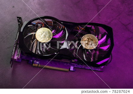 On the fans of a powerful video card, the coins of the Bitcoin cryptocurrency with a red backlight are displayed. On the fans of a powerful video card, the coins of the Bitcoin cryptocurrency with a red backlight are displayed. 78287024