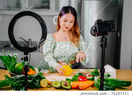 Asian woman blogger or content creator cooking and recording video camera. showing healthy food 78287311