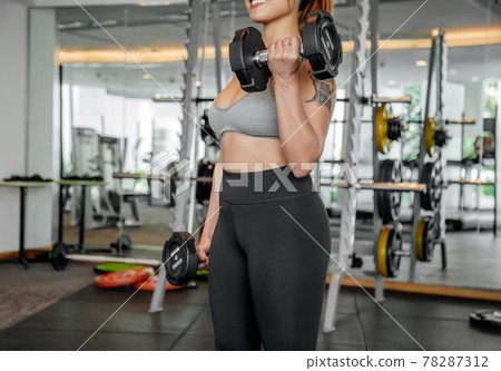 Asian sports woman in the gym, athletes training, workout lifting weight, plank and push up. tattoo Asian sports woman in the gym, athletes training, workout lifting weight, plank and push up. tattoo 78287312