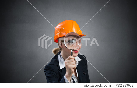 Technical inspector looking through magnifier 78288062