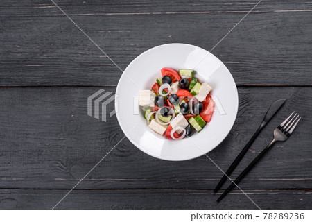 Fresh delicious Greek salad with tomato, cucumber, onions and olives with olive oil Fresh delicious Greek salad with tomato, cucumber, onions and olives with olive oil 78289236