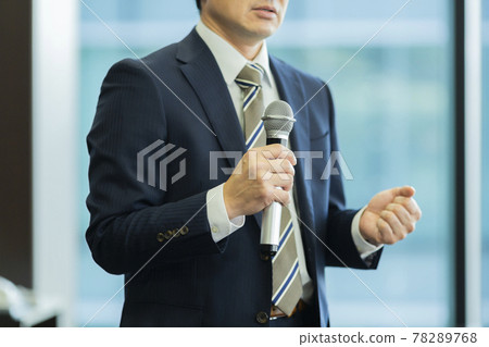A businessman talking with a microphone A businessman talking with a microphone 78289768