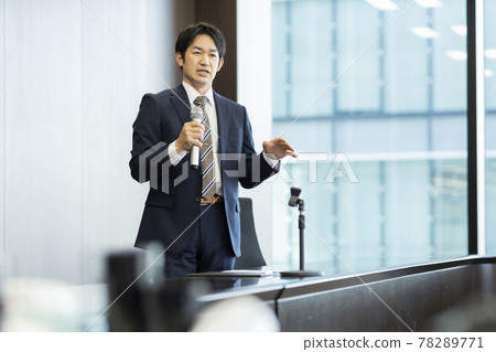 A businessman talking with a microphone A businessman talking with a microphone 78289771