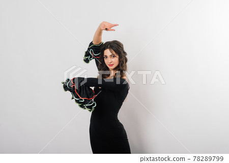 Portrait of beautiful young woman dancing flamenco in studio Portrait of beautiful young woman dancing flamenco in studio 78289799