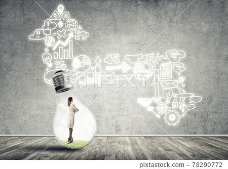 Businesswoman trapped in bulb Businesswoman trapped in bulb 78290772