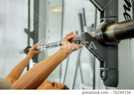 Asian sports woman in the gym, athletes training, workout lifting weight, plank and push up. tattoo Asian sports woman in the gym, athletes training, workout lifting weight, plank and push up. tattoo 78294156