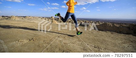 Fitness woman trail runner cross country running on sand desert 78297551