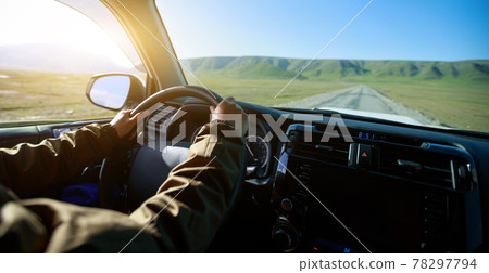 Driving offroad car on trail in high altitude grassland Driving offroad car on trail in high altitude grassland 78297794