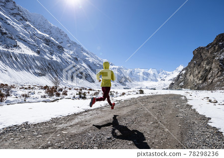 Woman trail runner cross country running in winter nature 78298236