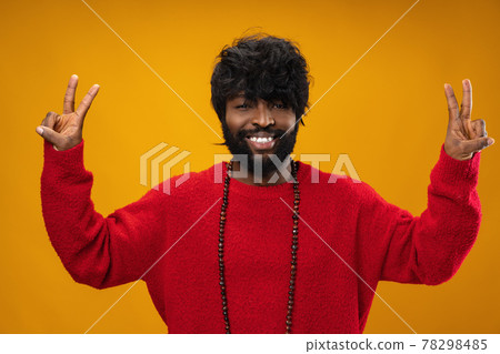 Portrait of smiling young black man in studio 78298485