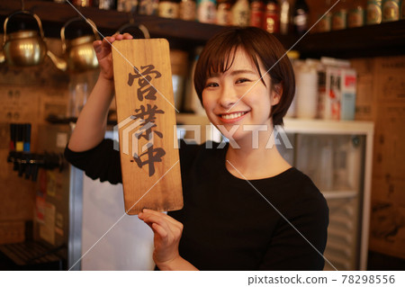 Female clerk with a "open" sign 78298556