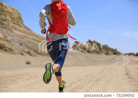 Fitness woman trail runner cross country running on sand desert Fitness woman trail runner cross country running on sand desert 78299092