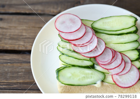 Cucumber and radish open sandwich with topping 78299118