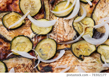 Close-up of pizza topped with grilled eggplant, zucchini and onion. Macro shot of delicious products. Close-up of pizza topped with grilled eggplant, zucchini and onion. Macro shot of delicious products. 78302177