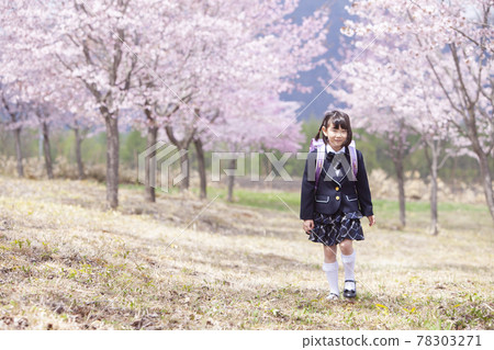 First grader carrying a school bag First grader carrying a school bag 78303271