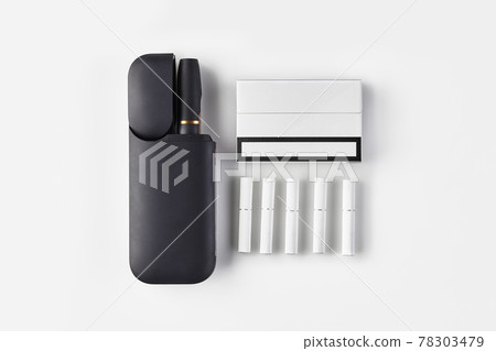 New generation black electronic cigarette in open battery, one pack, five heatsticks isolated on white. Hi-tech heating tobacco system. Close up 78303479