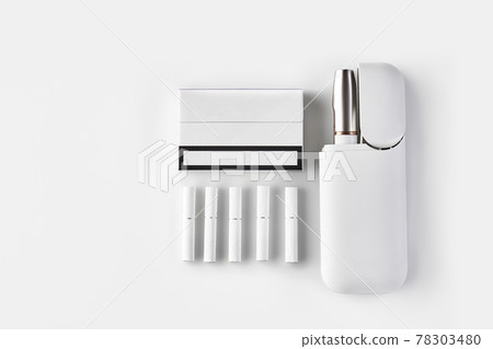 New generation electronic cigarette in open battery, one pack, five heatsticks isolated on white. Hi-tech heating tobacco system. Close up 78303480