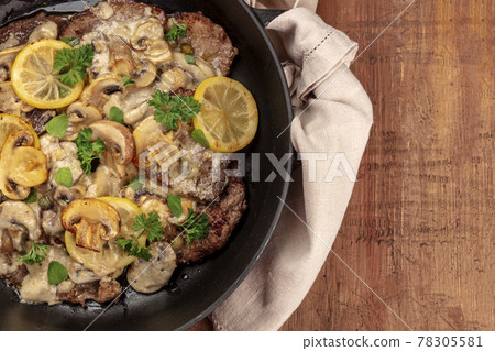 A closeup photo of scallopine di vitello, veal scallopini, a traditional Italian dish A closeup photo of scallopine di vitello, veal scallopini, a traditional Italian dish 78305581