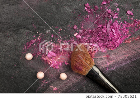 Closeup of makeup brush with eye shadows on black with copy space 78305621