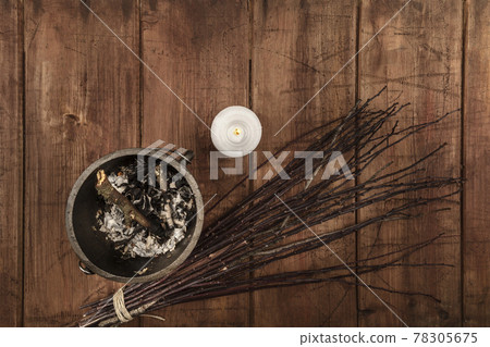 Overhead photo of cauldron, a candle, and a broom, wicca symbols 78305675