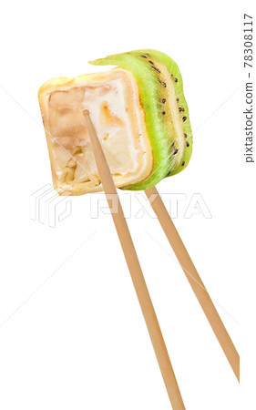 chopsticks holding sushi roll 78308117