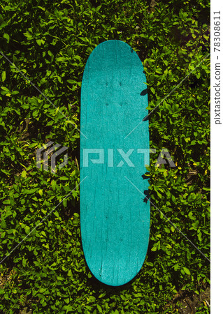 Green wooden skateboard. Skateboarding background, street sport. Green wooden skateboard. Skateboarding background, street sport. 78308611