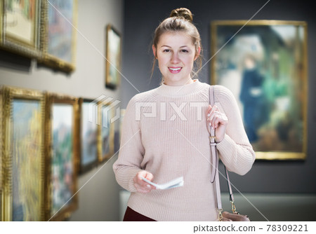 Woman with guide looking at pictures in museum 78309221