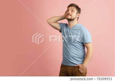 Half-length portrait of young Caucasian man isolated on light pink background. Half-length portrait of young Caucasian man isolated on light pink background. 78309551