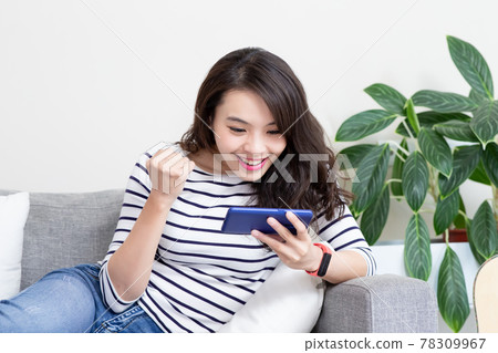 asian woman palys mobile games asian woman palys mobile games 78309967