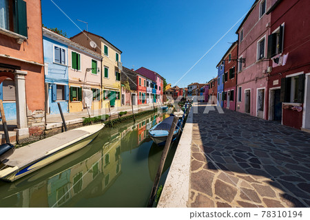 Burano Island in Venice Lagoon Italy - Multi Colored Houses and Canal with Small Boats Burano Island in Venice Lagoon Italy - Multi Colored Houses and Canal with Small Boats 78310194